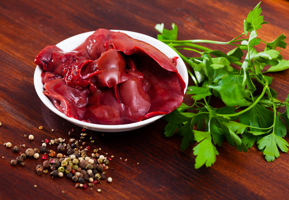 Cooking rabbit liver with parsley and garlic on the table