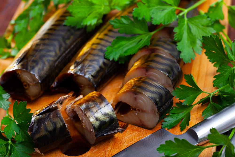 Smoked mackerel slices with greens
