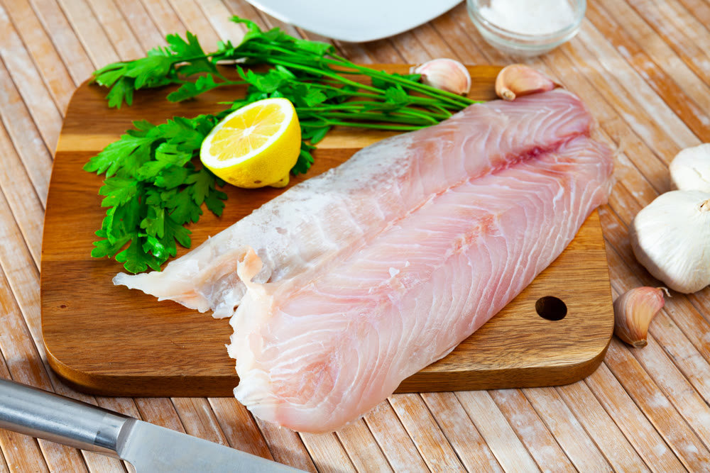 Raw seafood, fresh perch fillet on board