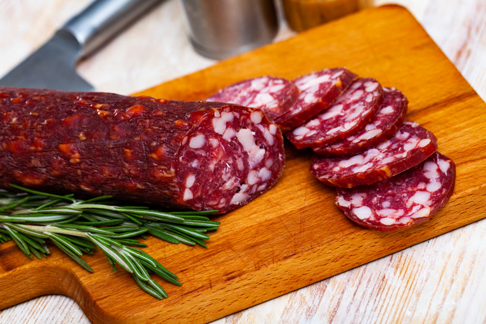 Tasty dried semi-dry sausage Braunschweig with rosemary