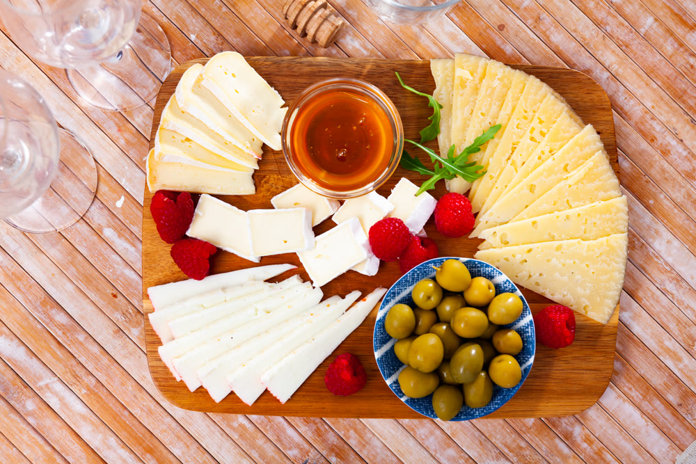 Cheese plate with raspberry and olives