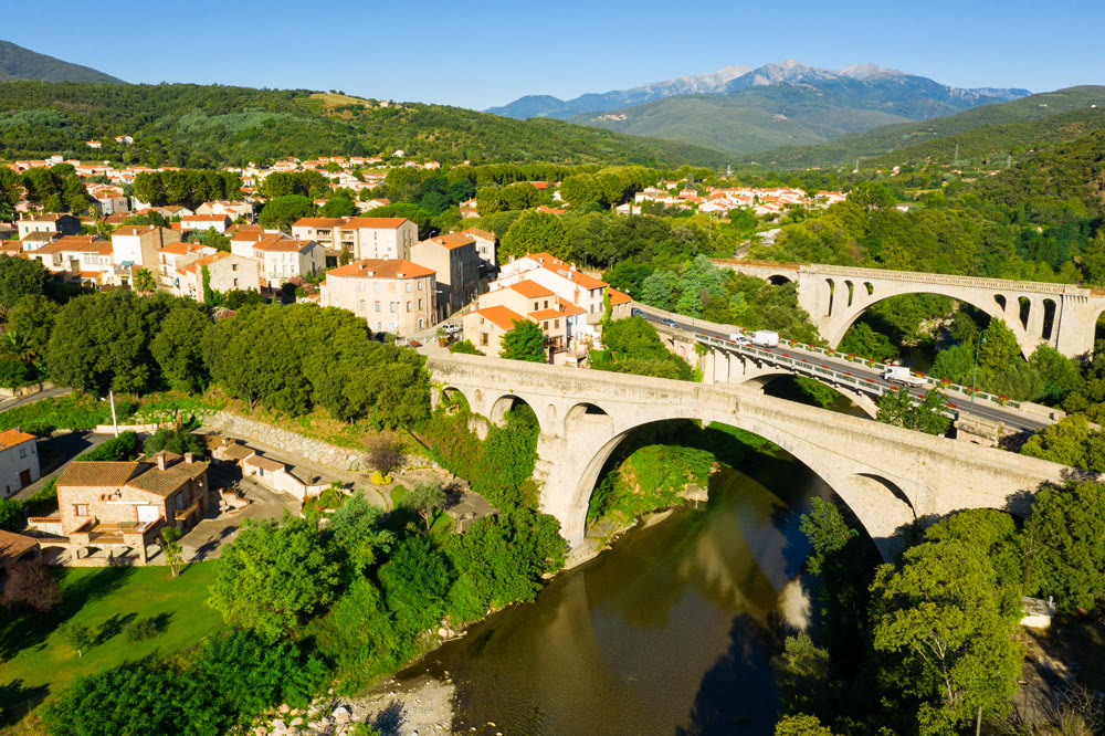Flight over the city Ceret on summer day