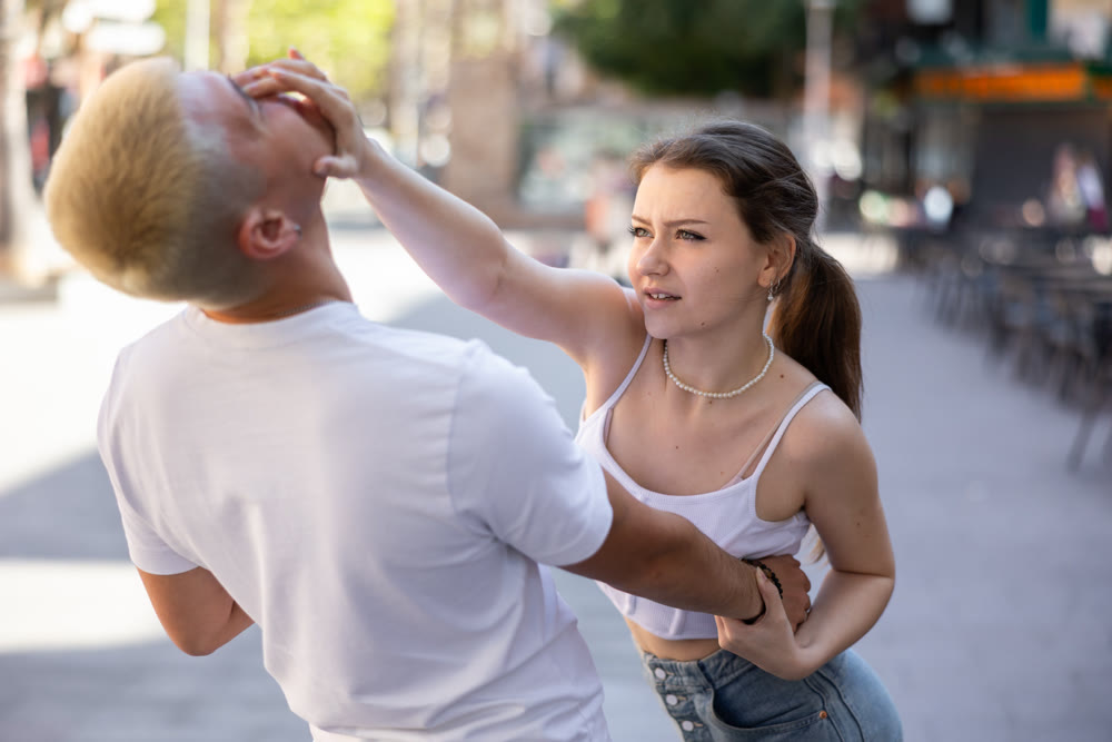 Young woman using self-defense technique