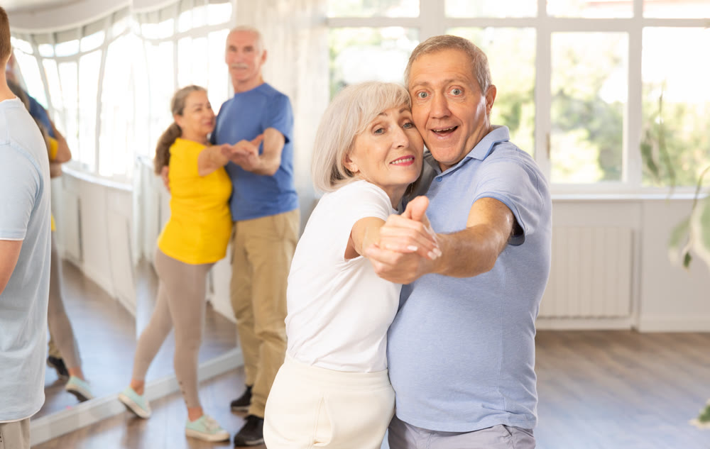 Couple of elderly man and woman dancing waltz