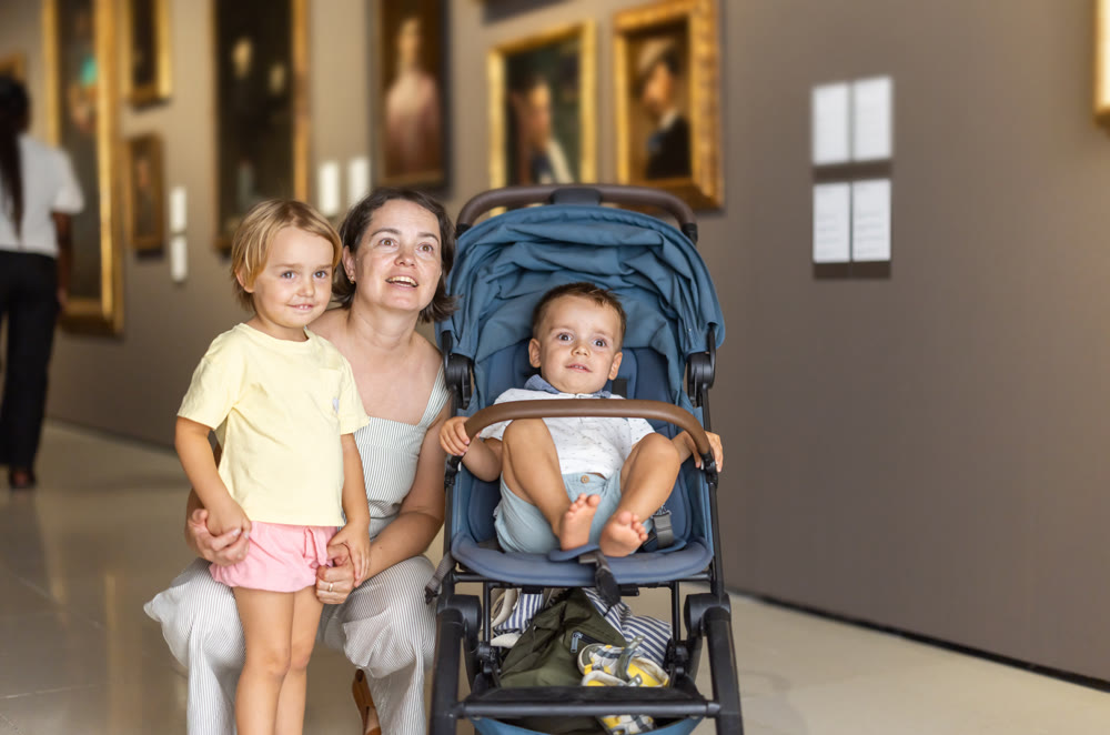 Mother and kids exploring picture exhibition in museum